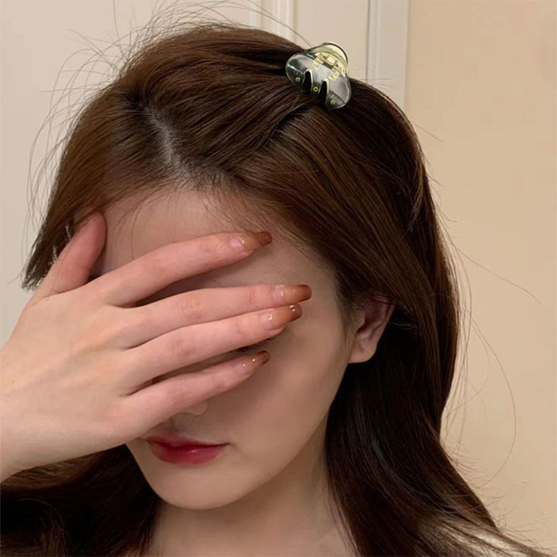 Pinza de plástico para el cabello con dientes inclinados e inyección